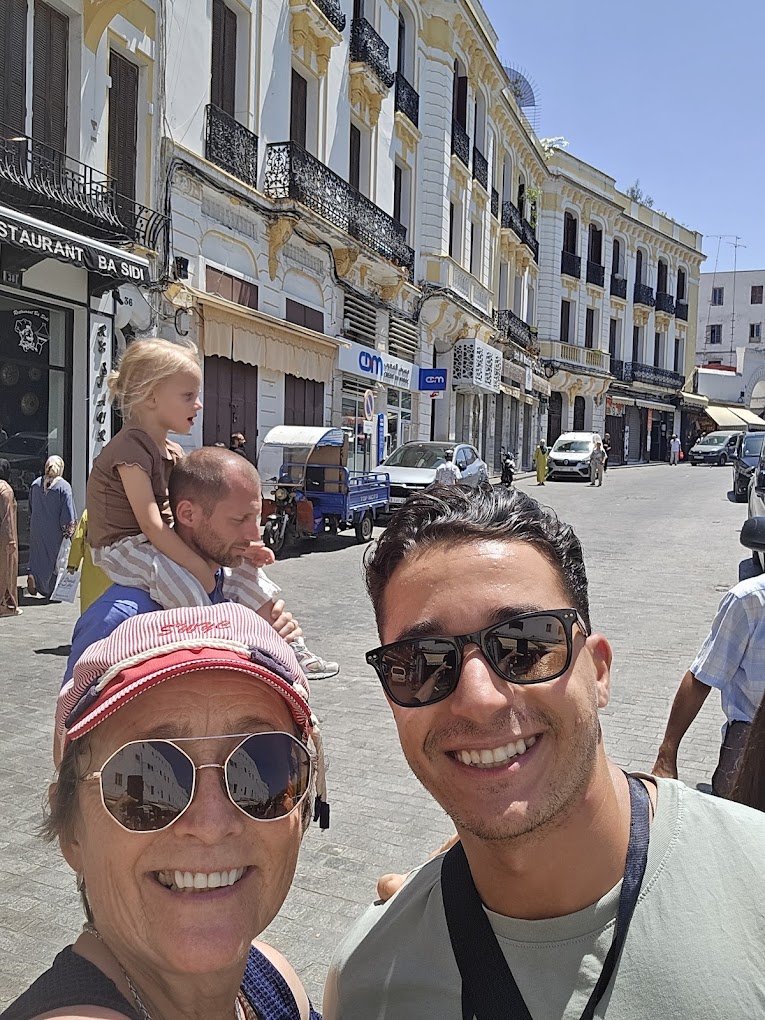 Visitors walking a narrow street in the Tangier Medina